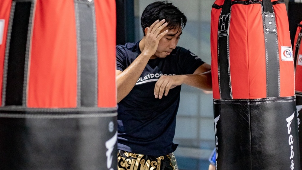 A Student engaging in a Muay Thai class at Evolve MMA.